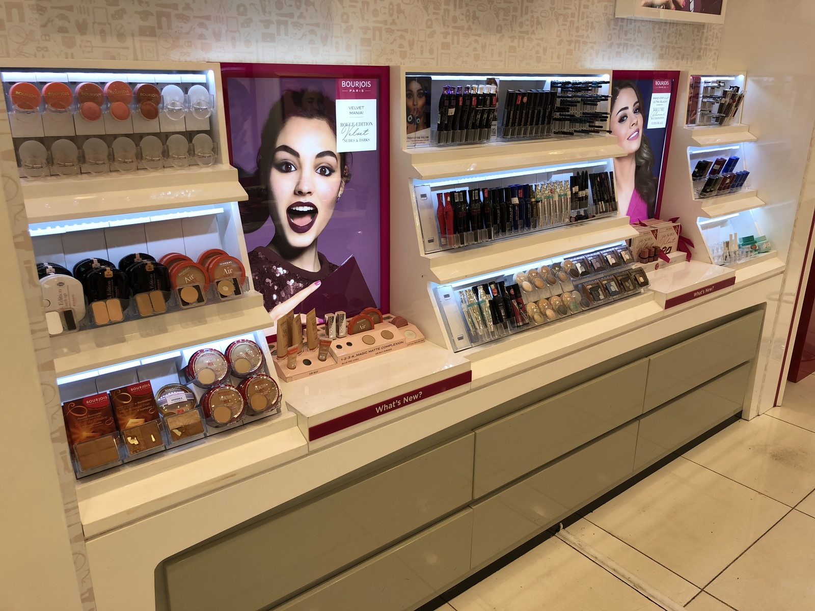 Wall-mounted display with backlit graphics and adjustable shelves